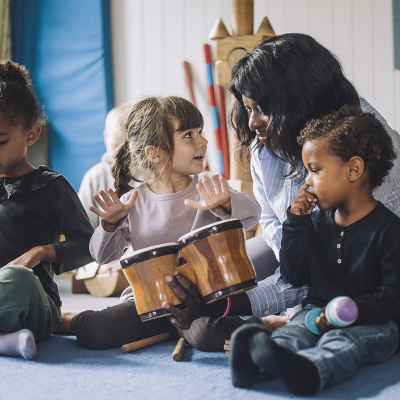 Children in a classroom playing instruments